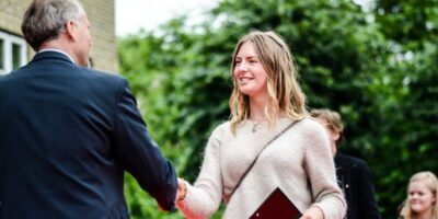 Headmaster Olav awards diploma to student