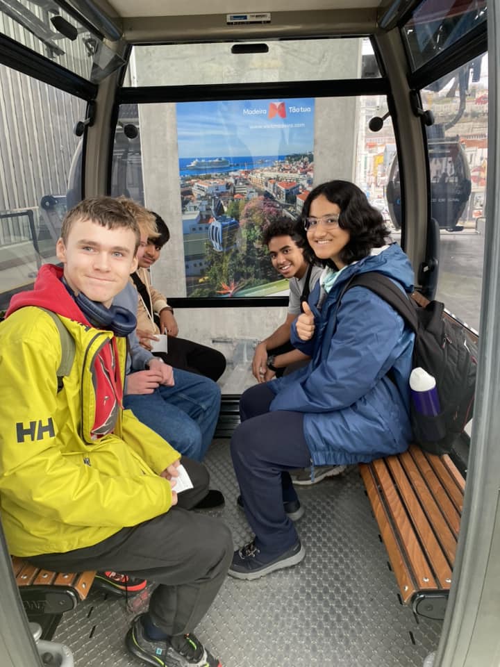 five boys sitting in a lift looking out