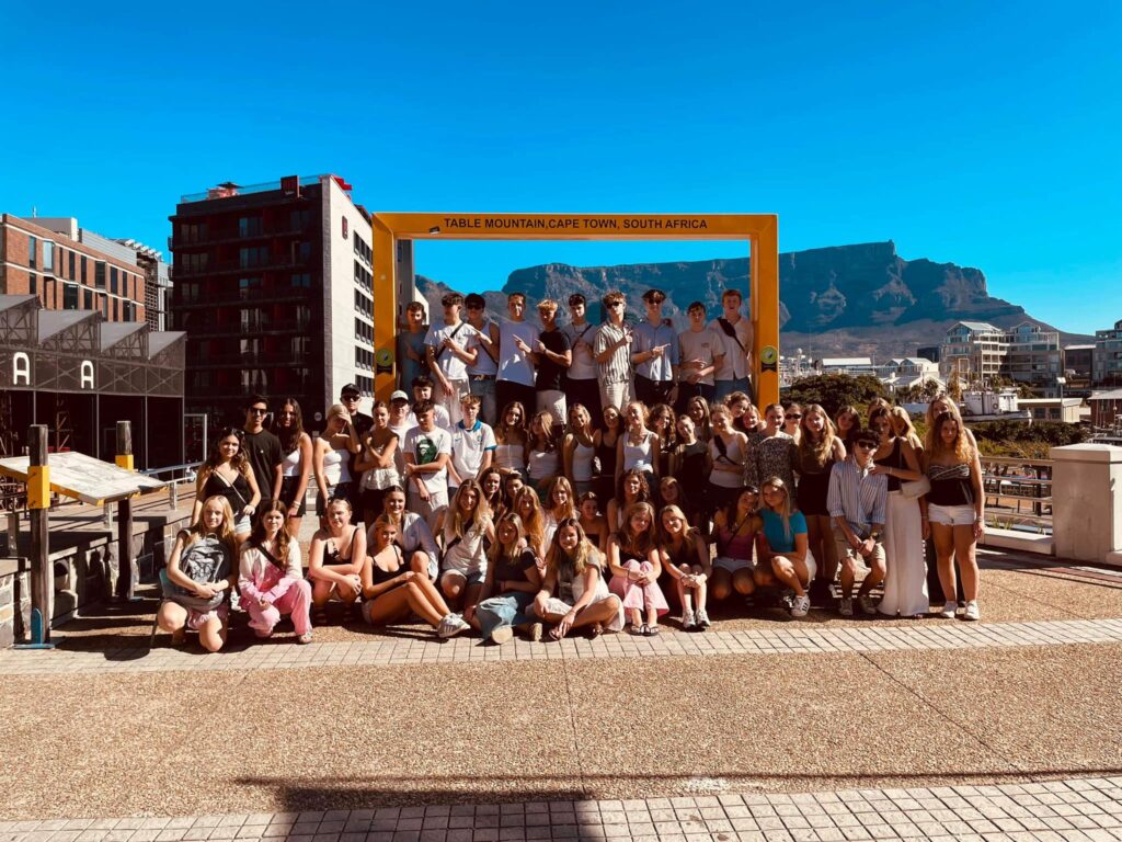 Students gathered with mountains in the background