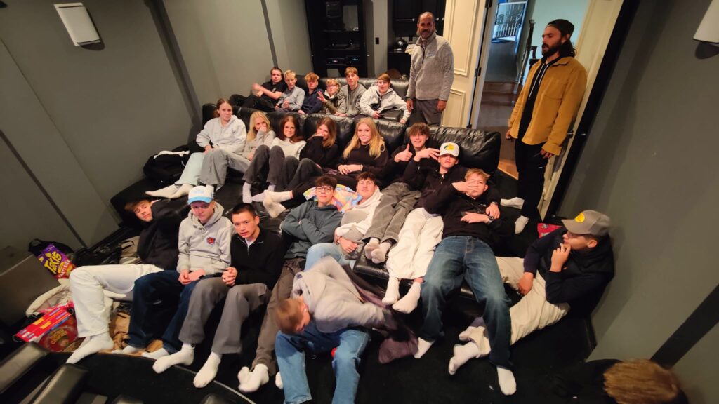 After-school students lie on a large sofa close to each other