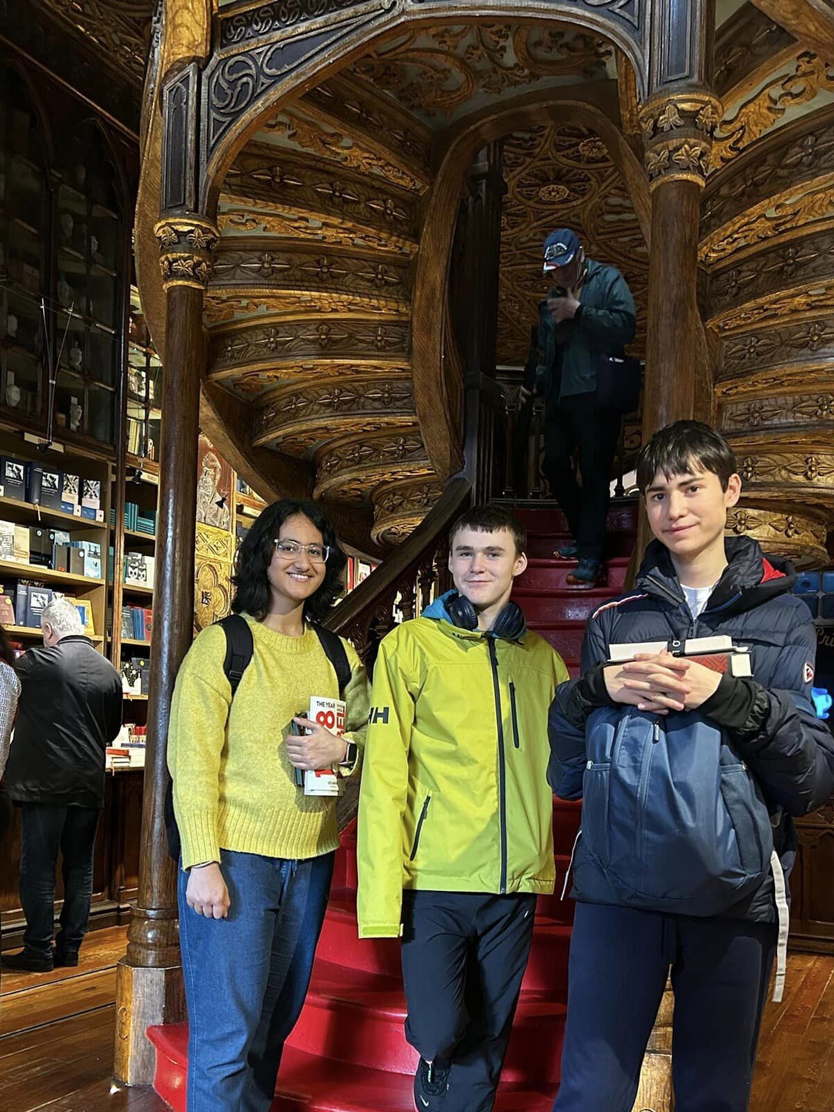 Three boys gathered in front of a staircase in Europe