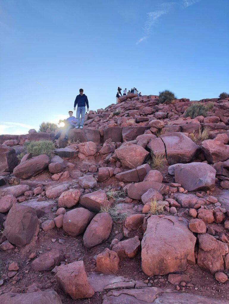 Students climb up and down a pile of rocks