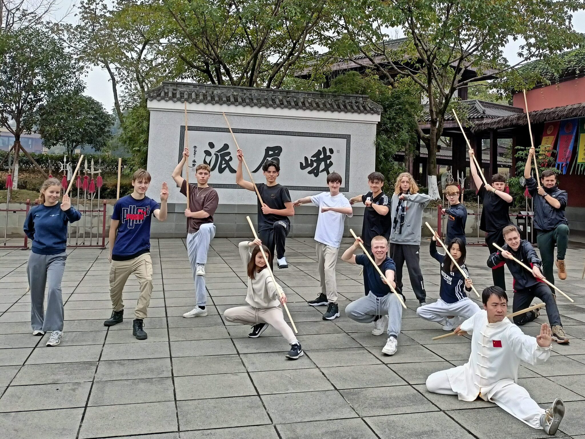 After-school student stands with a stick and practises martial arts