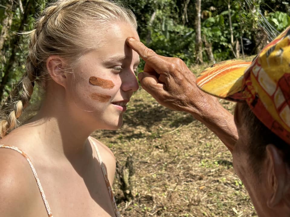 Danish girl gets painted on the head by a Costa Rican man