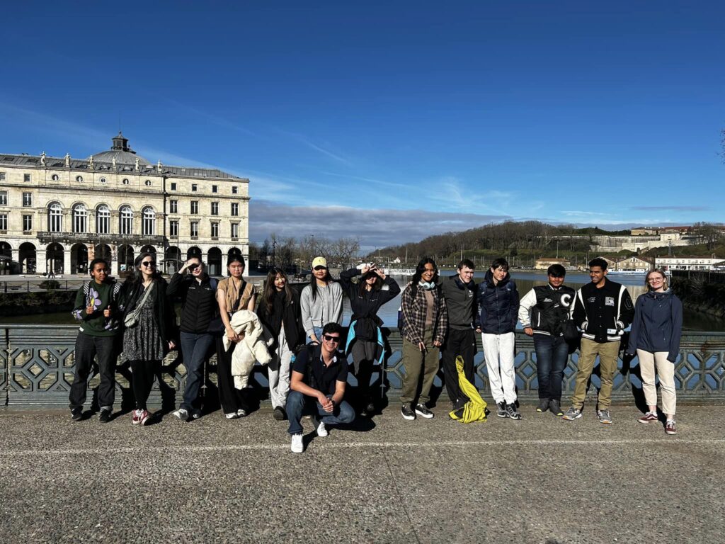 Students gathered with blue sky in the background