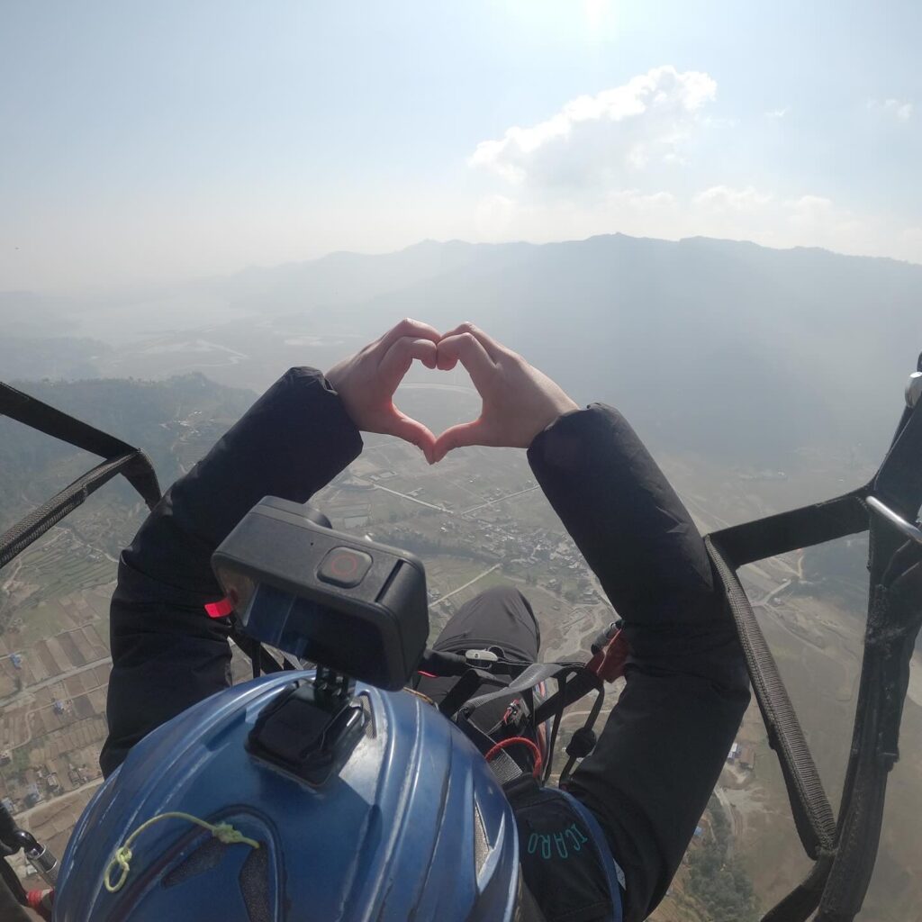 After-school student floats in the air and makes a heart with his hands