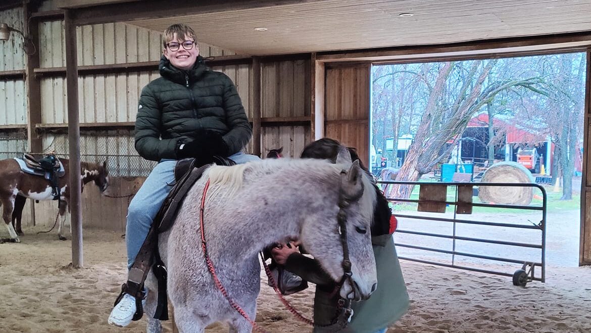 A boy sits on a horse