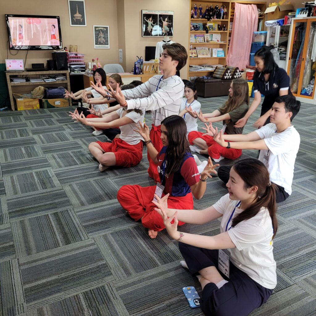 After-school students sit on the floor and practise taiji in Thailand