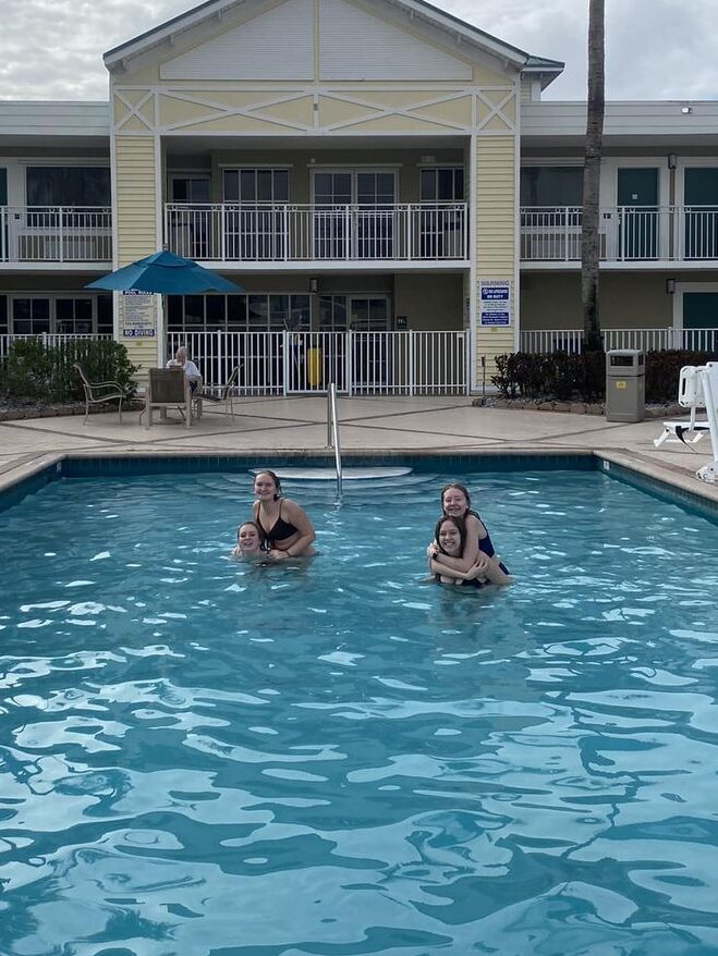 four girls swimming in a pool in the USA