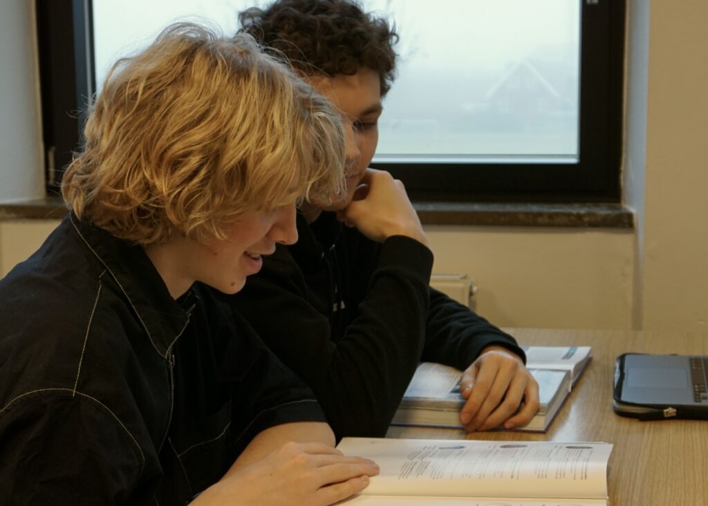 Two boys from Ranum Efterskole College look into a book