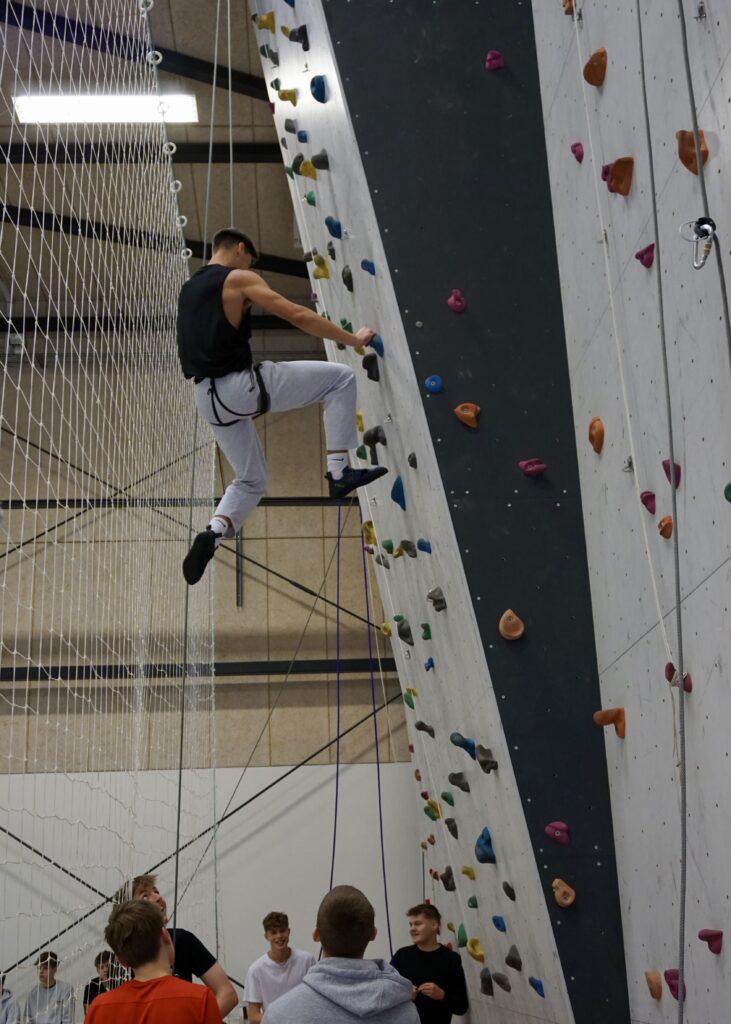 A boy climbing on a climbing wall 