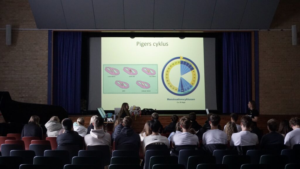 Students sitting in a room learning about girls' cycles