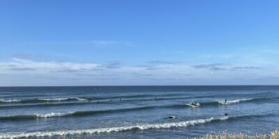 A beach with a surfboard