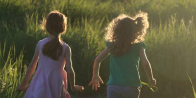 Children running through the grass